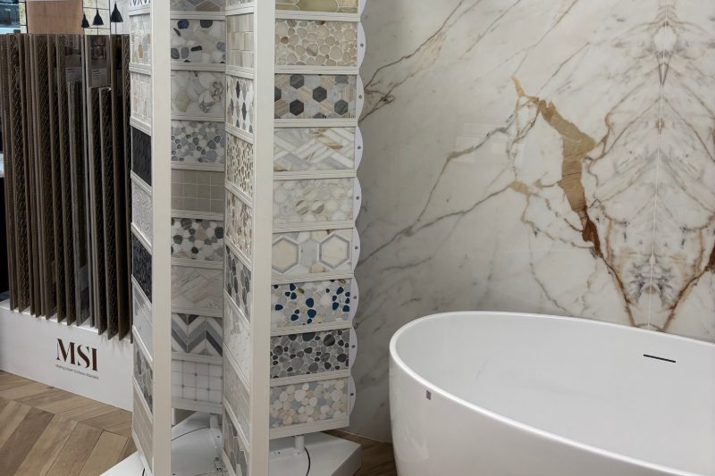 wall tile display next to soaking tub